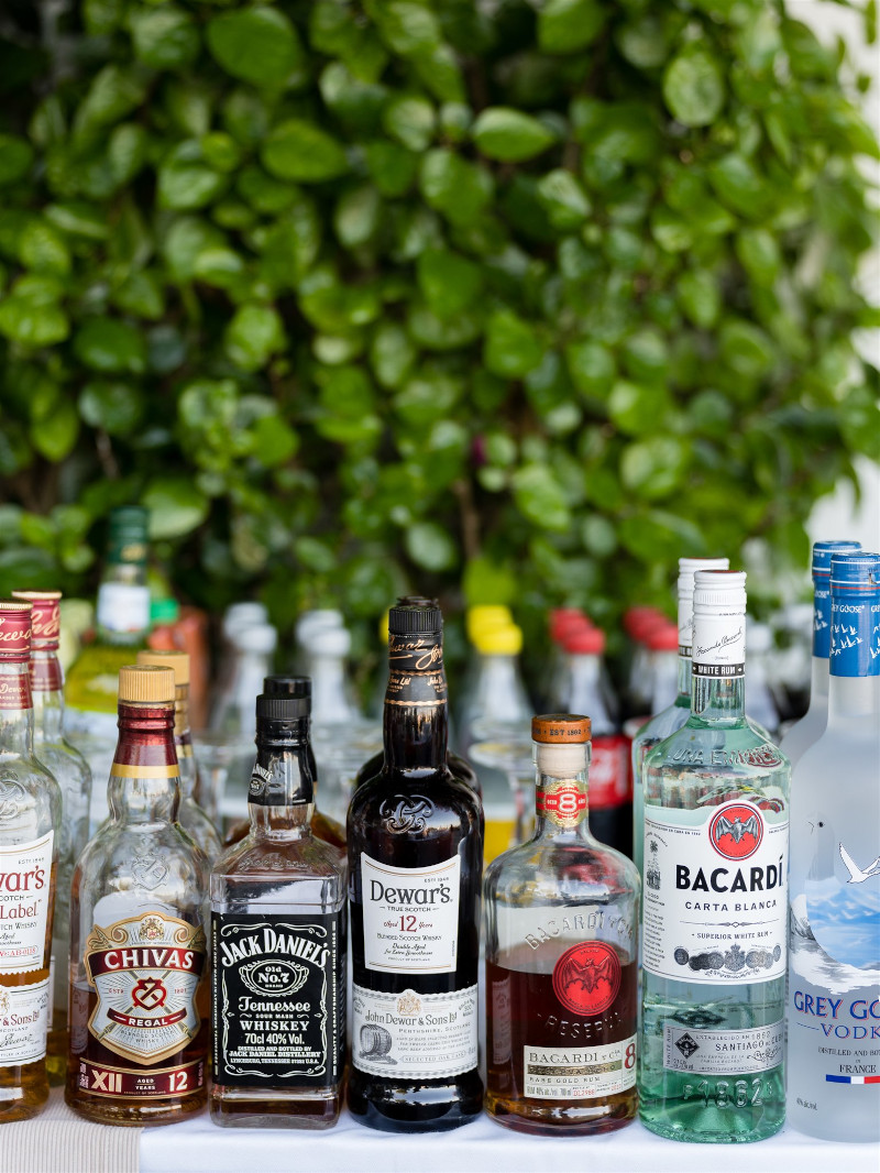 Mykonos wedding mini bar with multiple alcohol bottles, soft drinks and beverages 