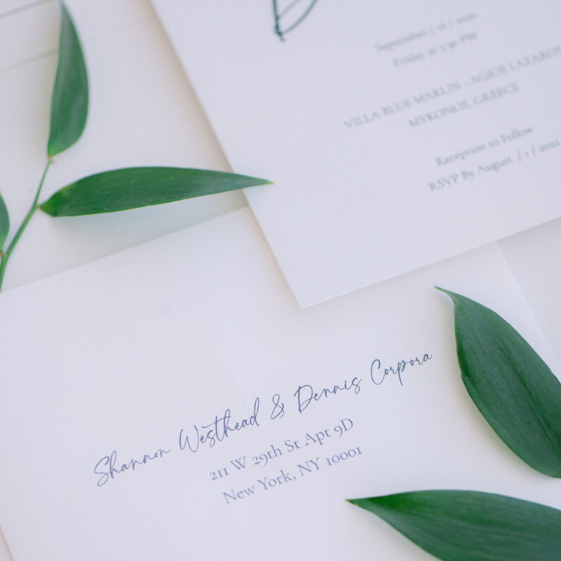Elegant wedding invitation with green leaves from Mykonos Wedding Press.